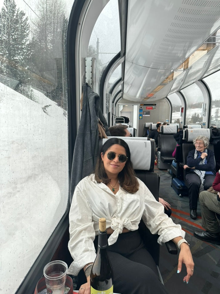 Jessica S, founder of WANDRVEL, on a panoramic train through the snow