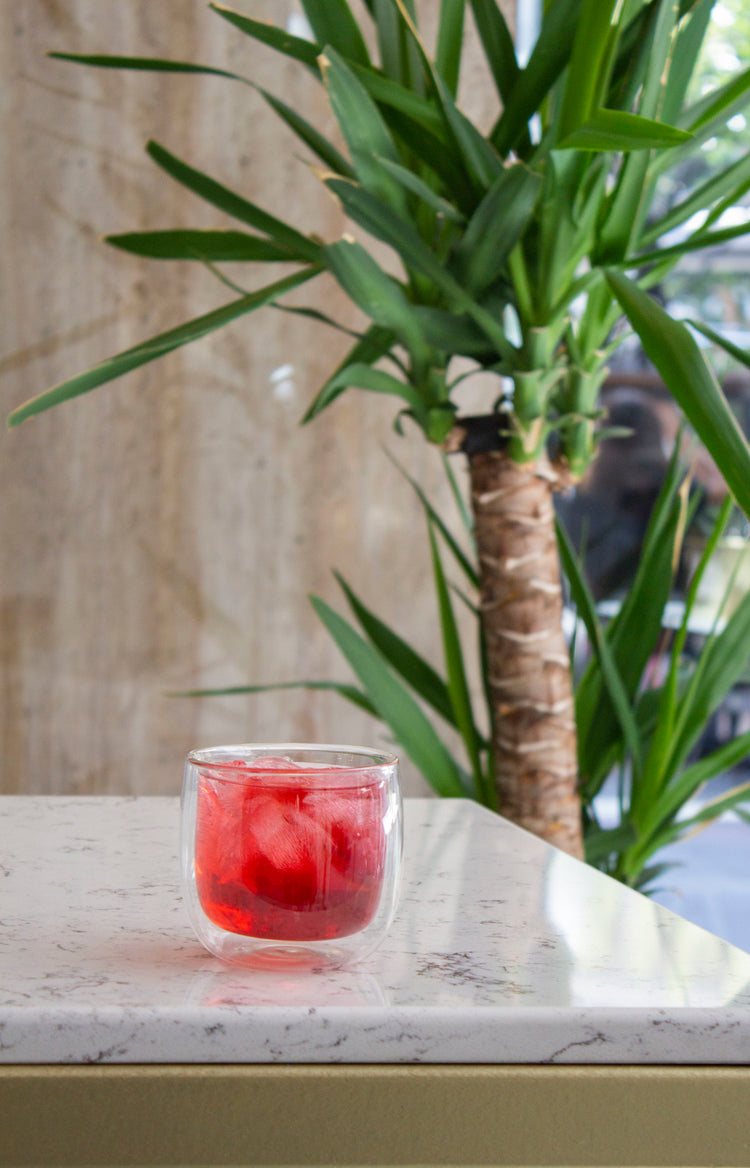 A glass of juice on a marble counter